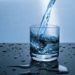 Filtered water pouring into a glass in a Suffolk County home