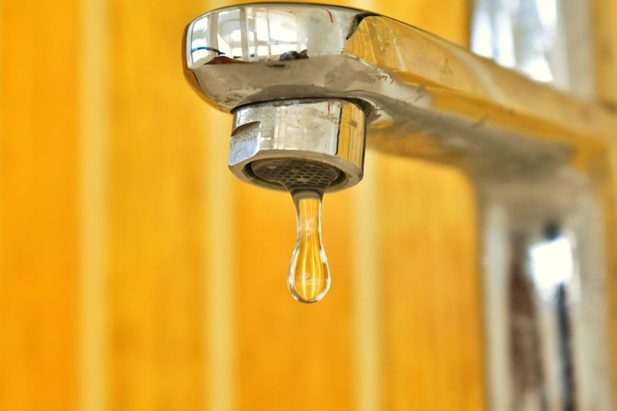 Illustration of common home plumbing problems like leaks and clogs in Suffolk County