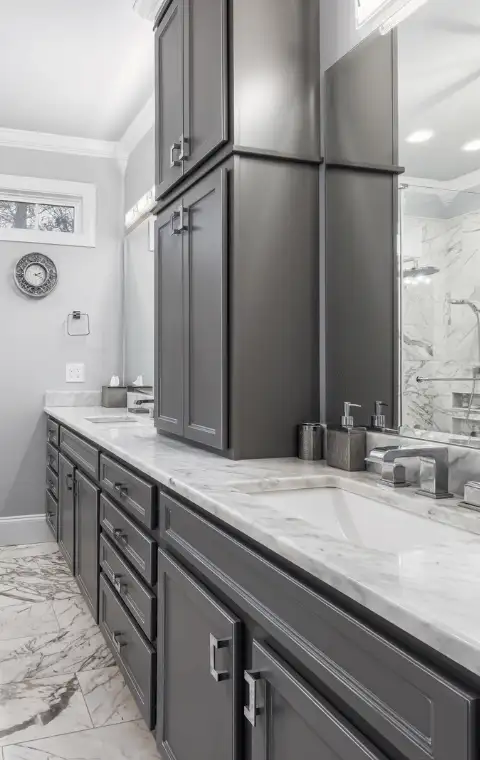 Clean modern bathroom with marble tile and double sink vanity in Suffolk County