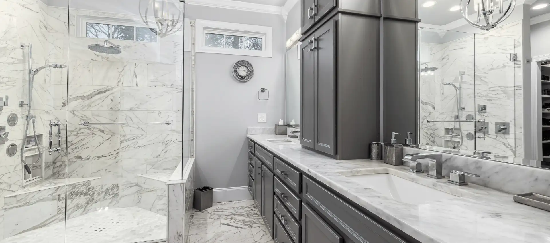 Clean modern bathroom with marble tile and double sink vanity in Suffolk County